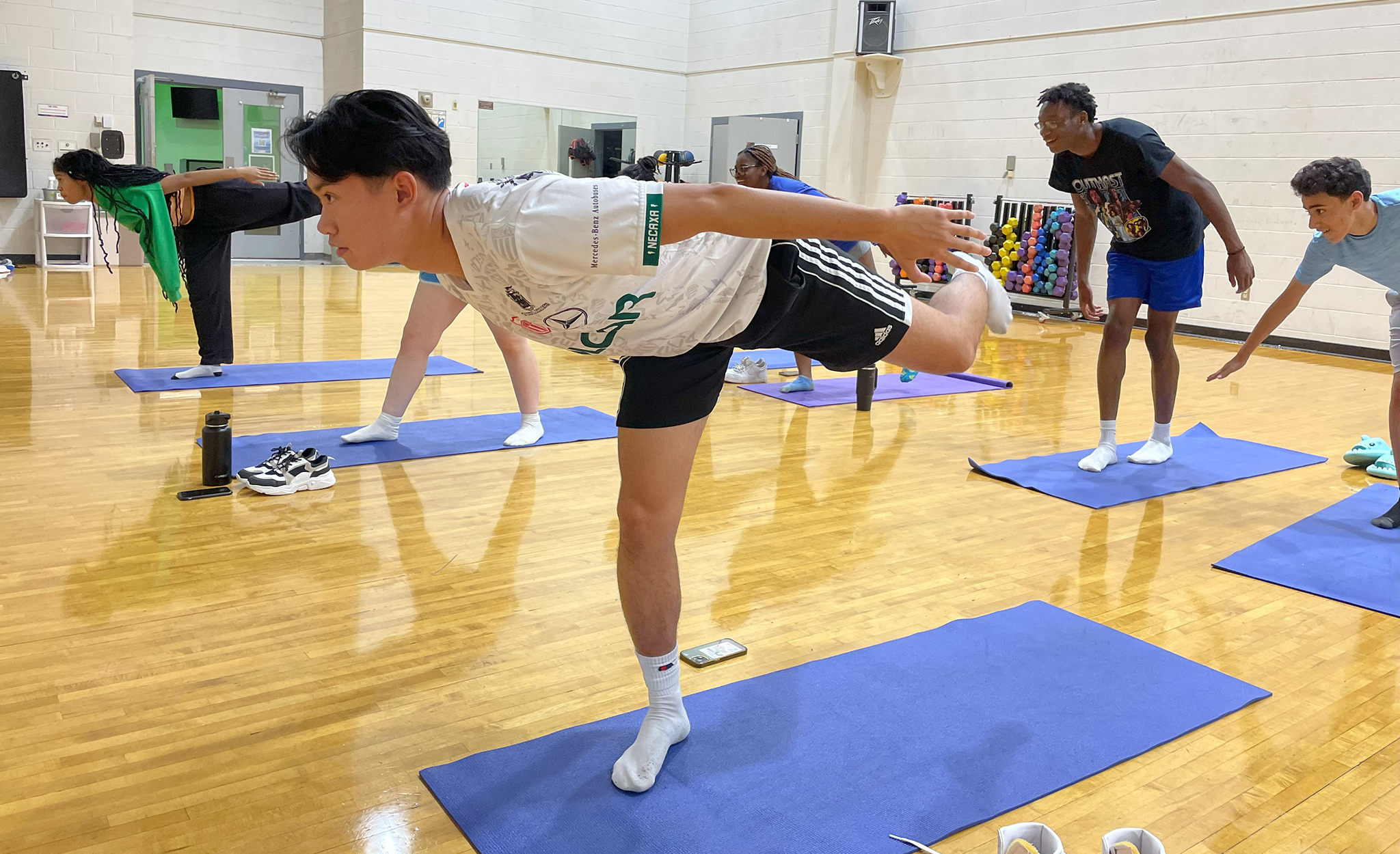 Students participate in yoga in a gym. 