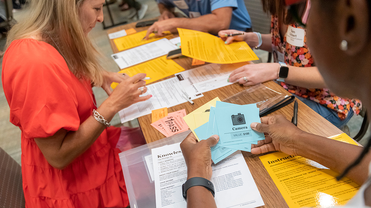 Participants consider their resources during a simulation at the Missouri Community Action Network Poverty Simulation on the UM campus. 