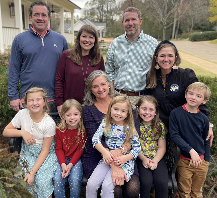 A group of people poses for a family photo together.