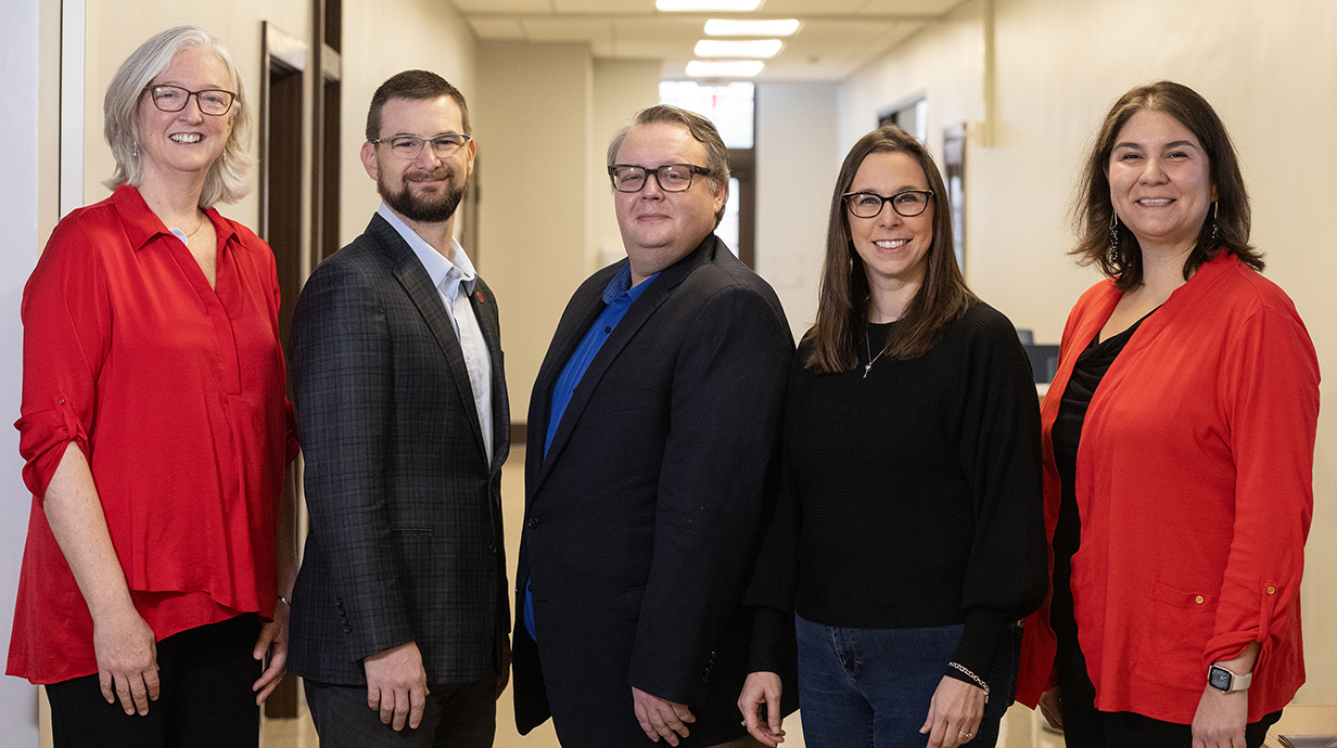 Program administrators stand in a hallway.