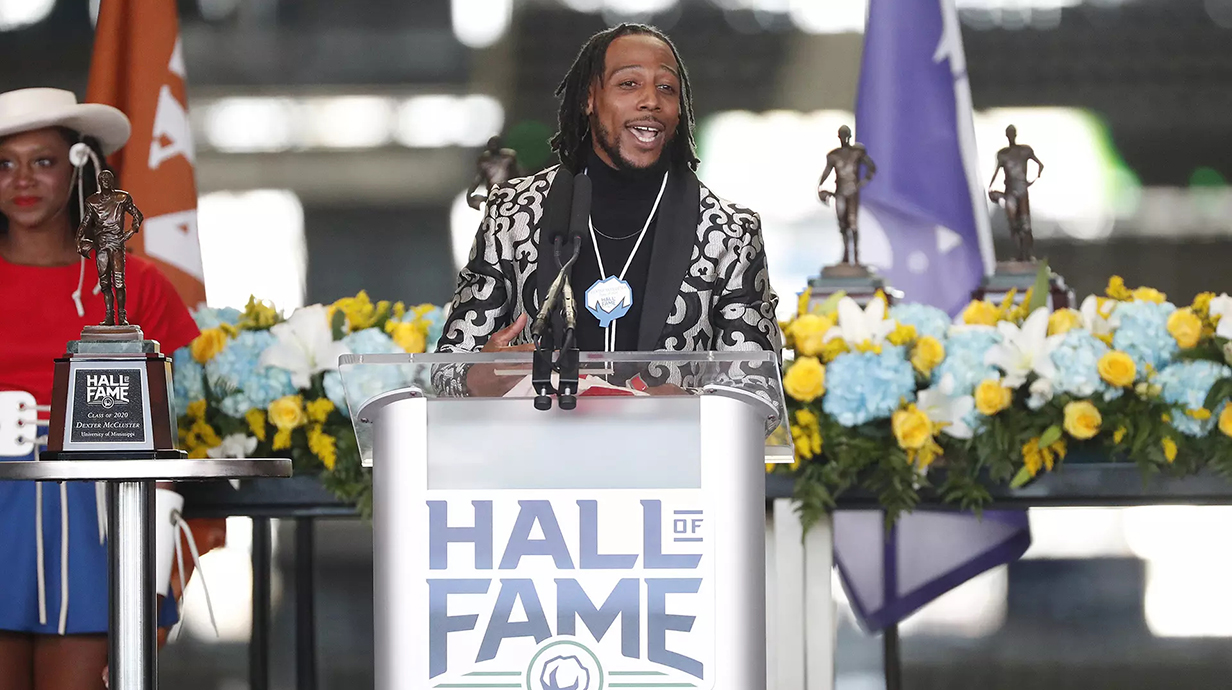 Dexter McCluster speaks from a podium at an awards ceremony.