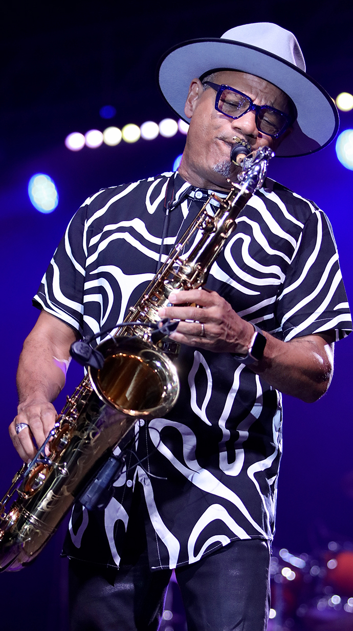 A musician plays a saxophone nstage.