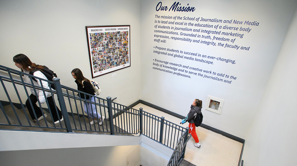 Students walk up a stairway in Farley hall.