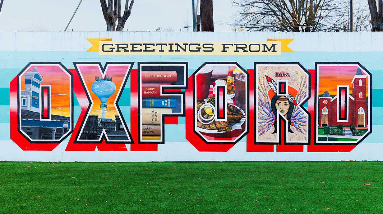 Mural on the side of a building reading 'Greetings from Oxford'