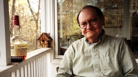 A man sits on a back porch