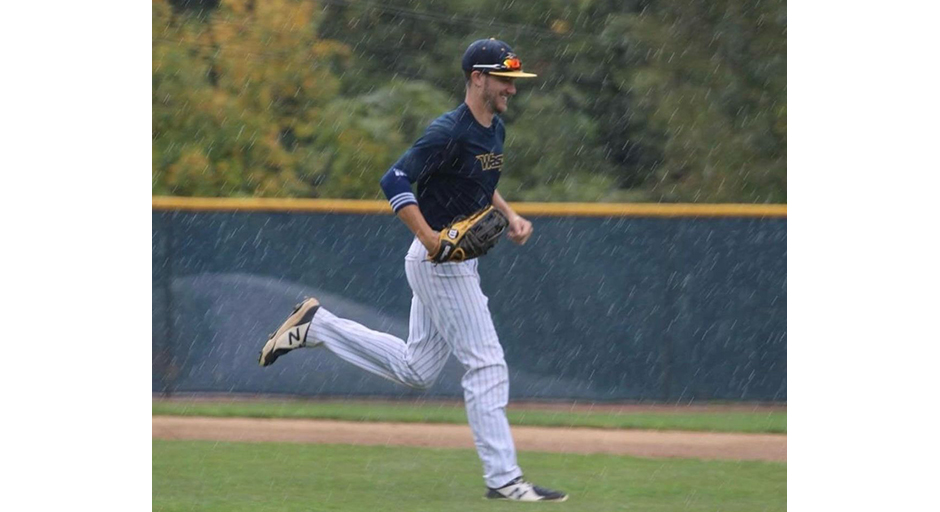 A baseball player runs through the rain