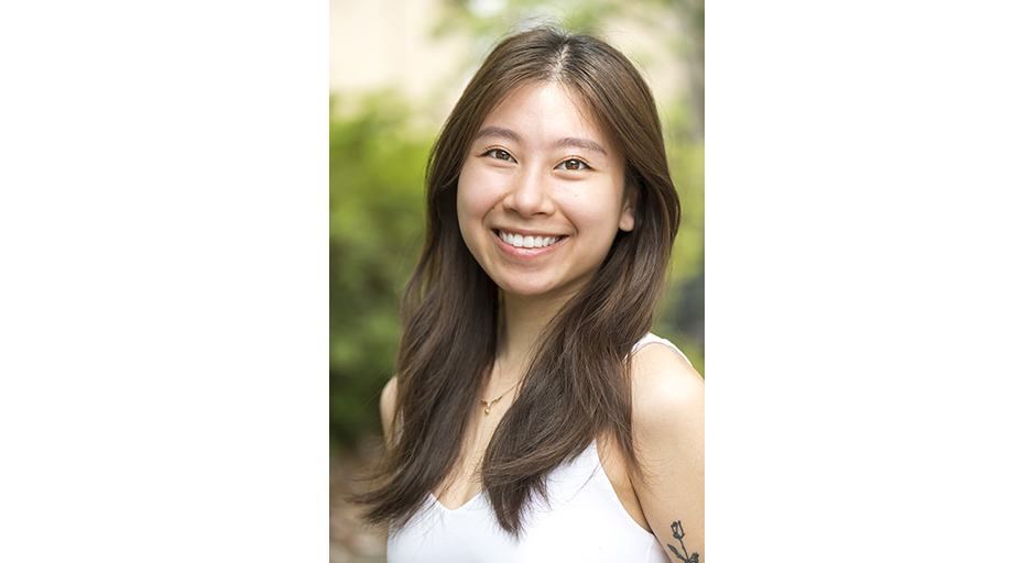 Portrait of a young lady wearing a white top.