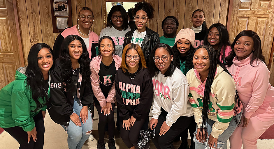 A group of young women pose for a group photo.