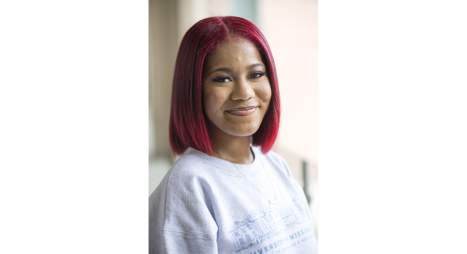 Portrait of a young woman with dyed red hair.