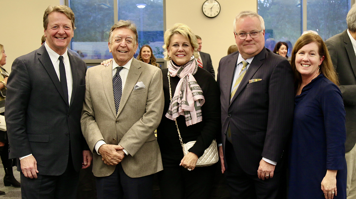 A group of people stands together at a reception.