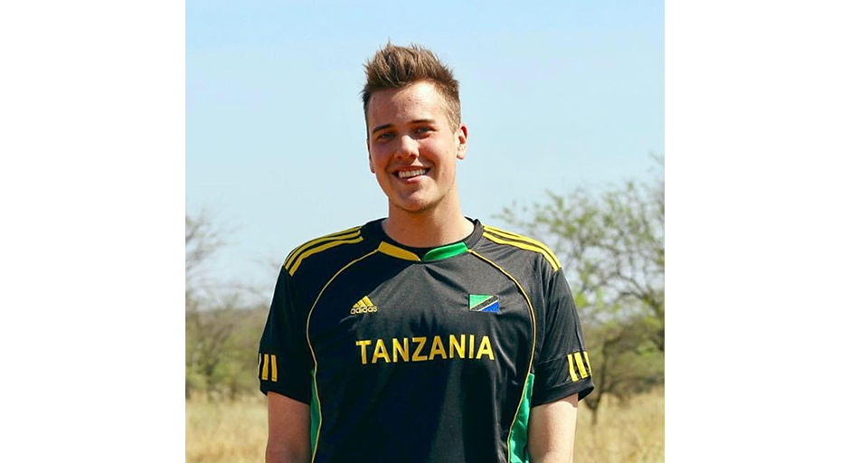 Photo fo a young man wearing a soccer jersey that reads 'Tanzania.'