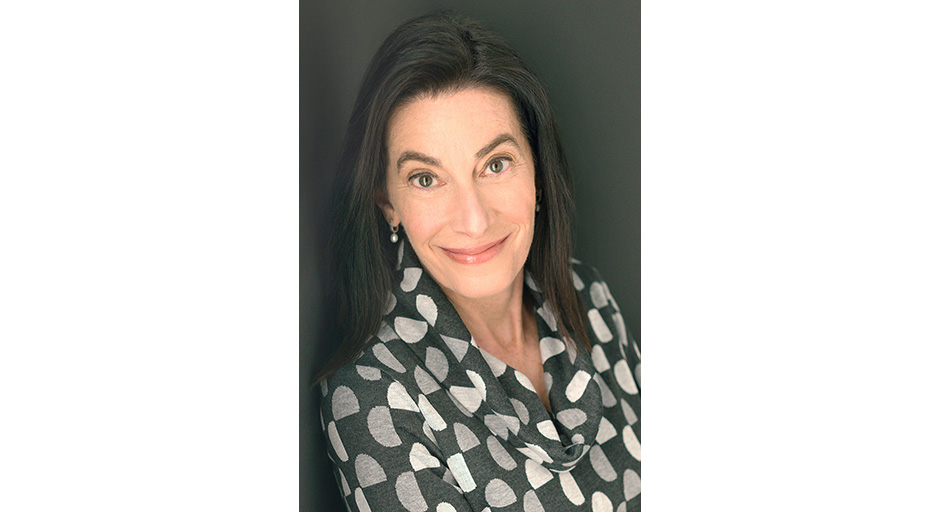 Portrait of a woman wearing a checked blouse.