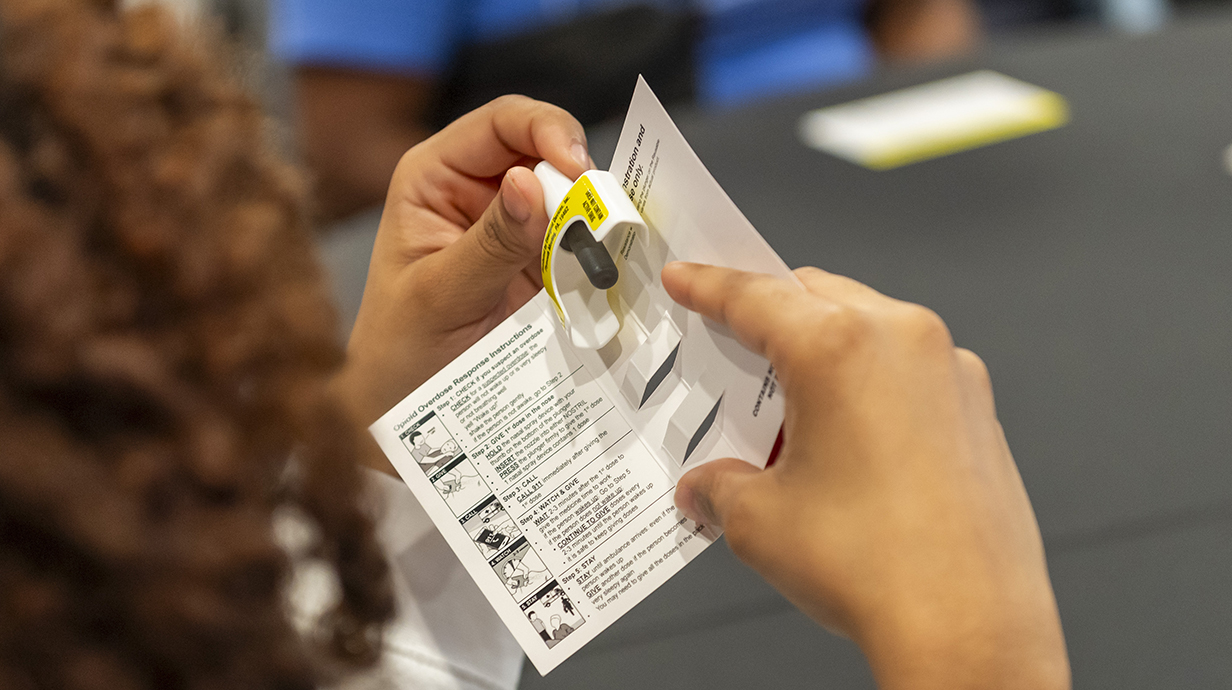 A woman's hands hold a fentanyl test kit.