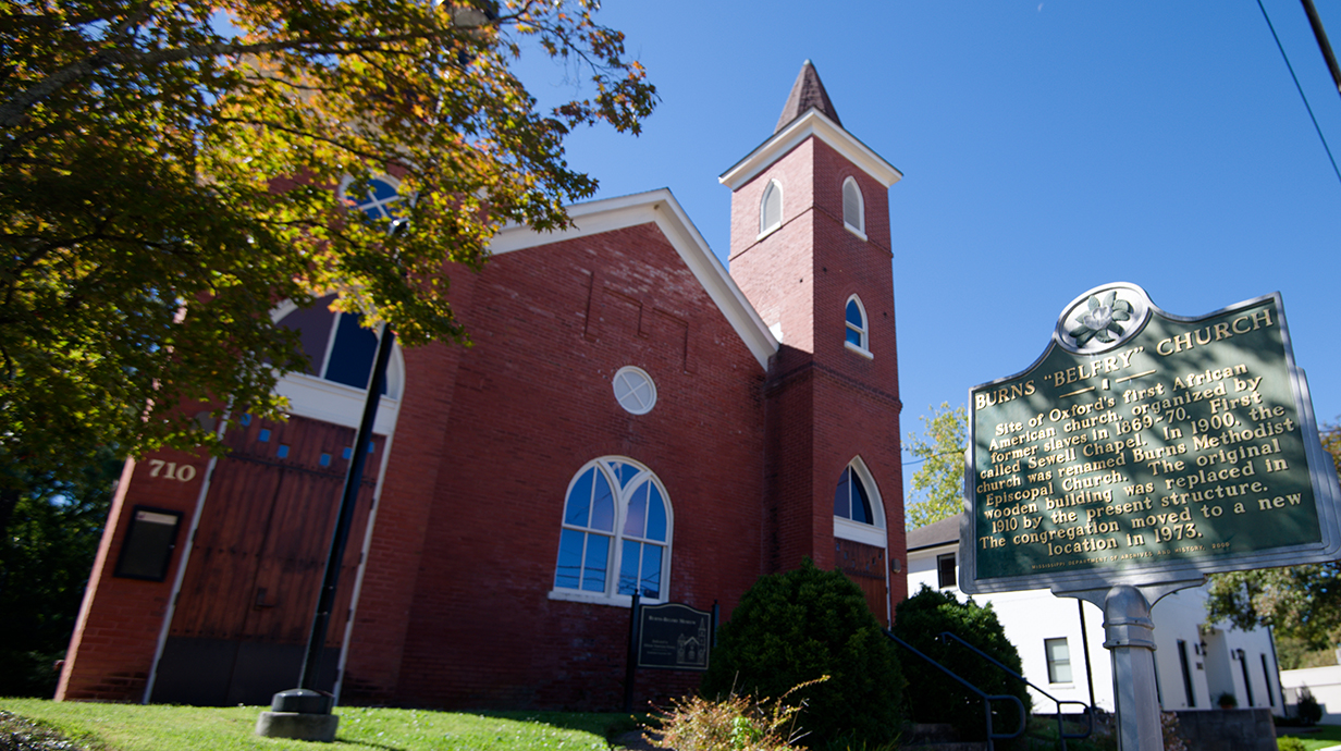 Exterior photo of a red brick church building.