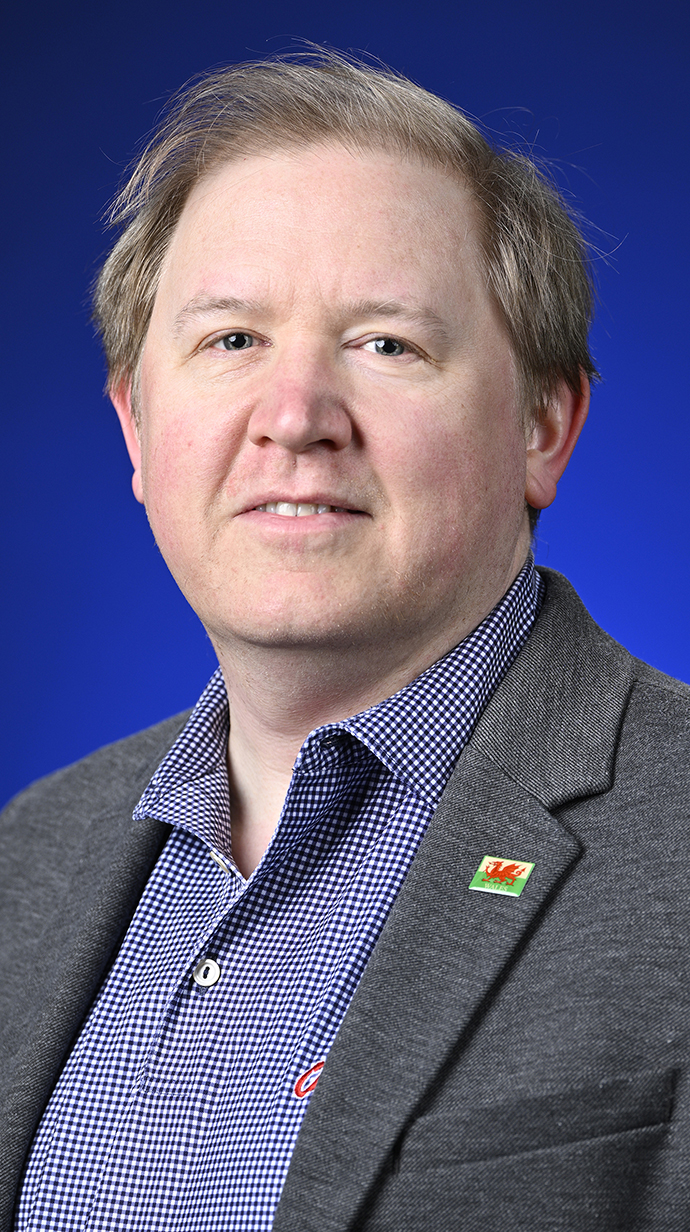 Headshot of a man wearing a gray sportcoat.