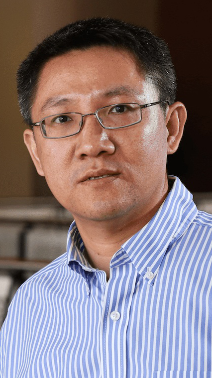 Headshot of a man wearing a blue-and-white striped shirt.