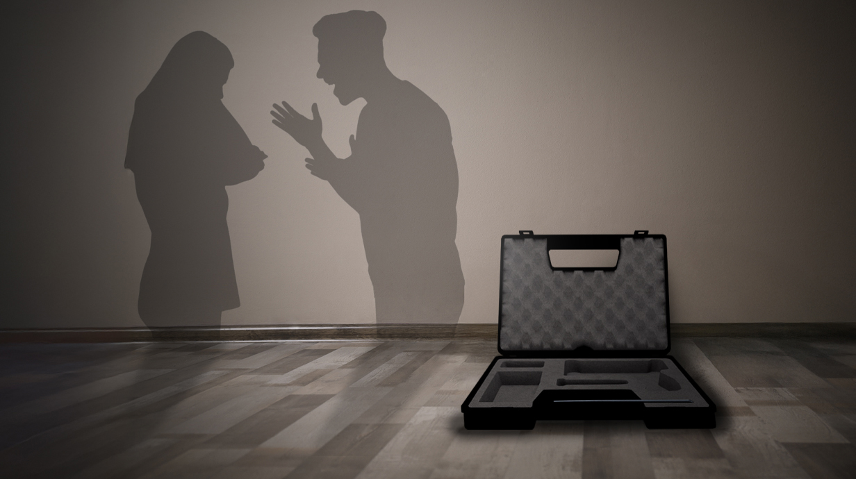 A silhouetted couple argues with an open gun case sitting in the foreground.