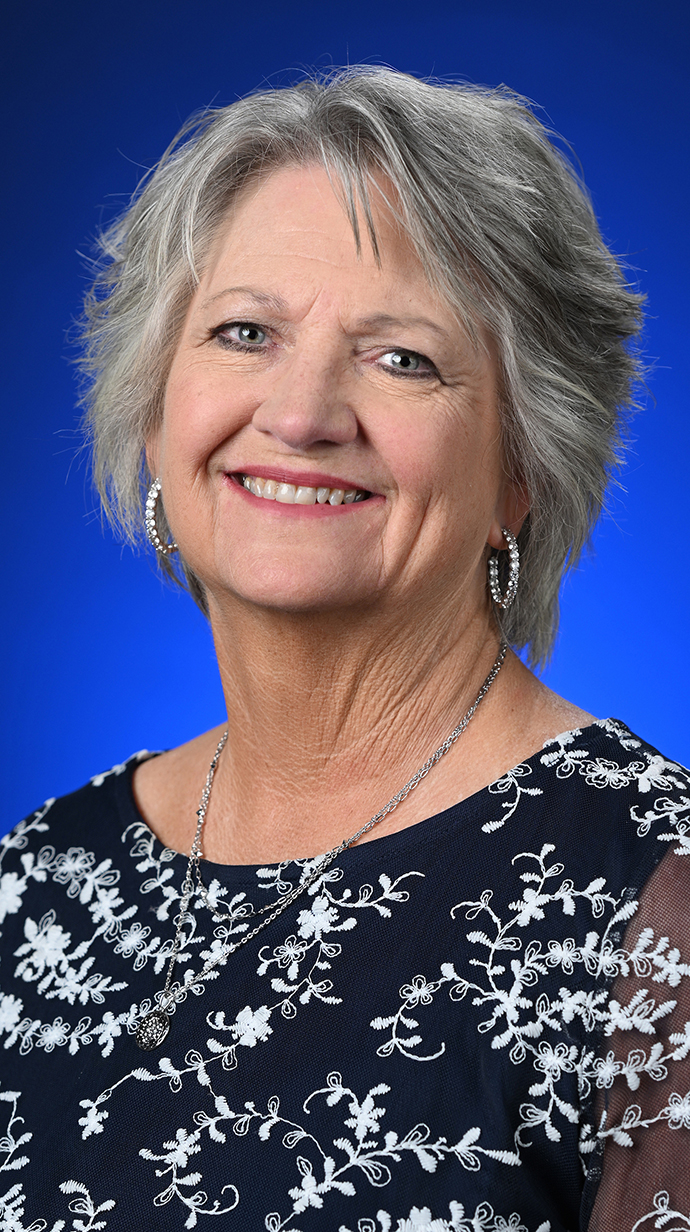 Headshot of a woman wearing a black dress.