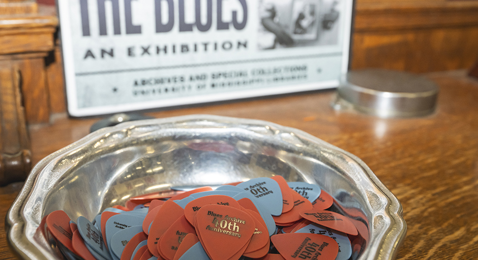 A small bowl of guitar picks sits on a table.
