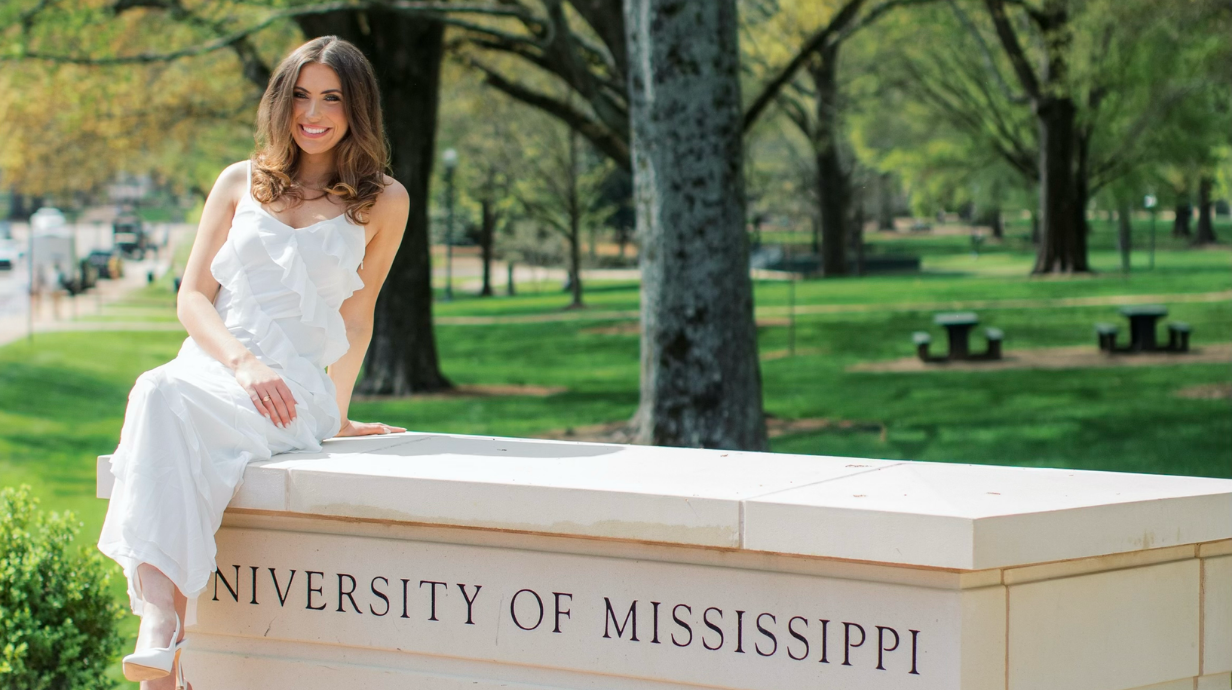 An image of Lauren Brown sitting on the Grove welcome area.