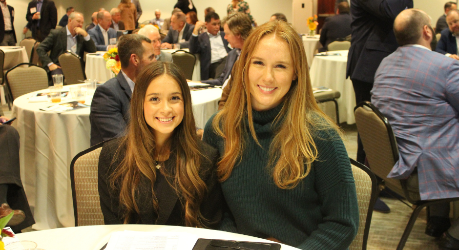 An image of Lauren Munnell and Samantha Hendrix sitting at a table at the 2023 Banking & Finance Symposium.