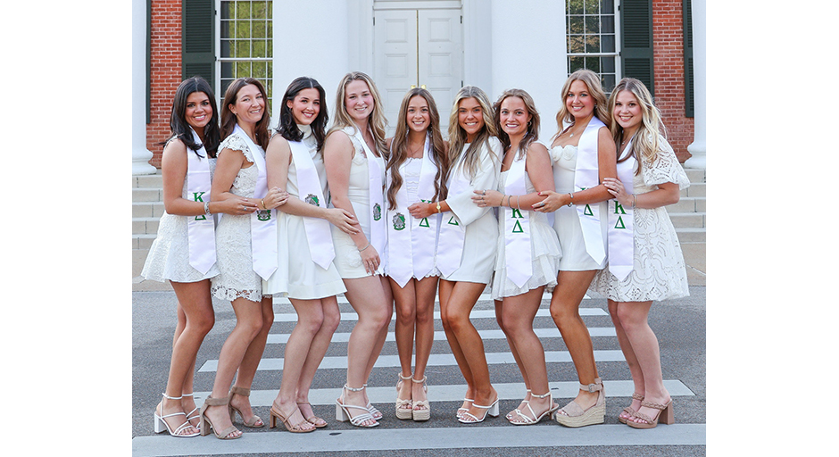An image of nine girls standing in front of the Lyceum.