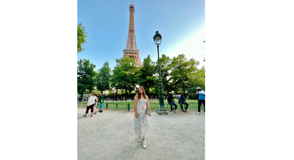 Photo of Caroline Brock in front of the Eiffel Tower