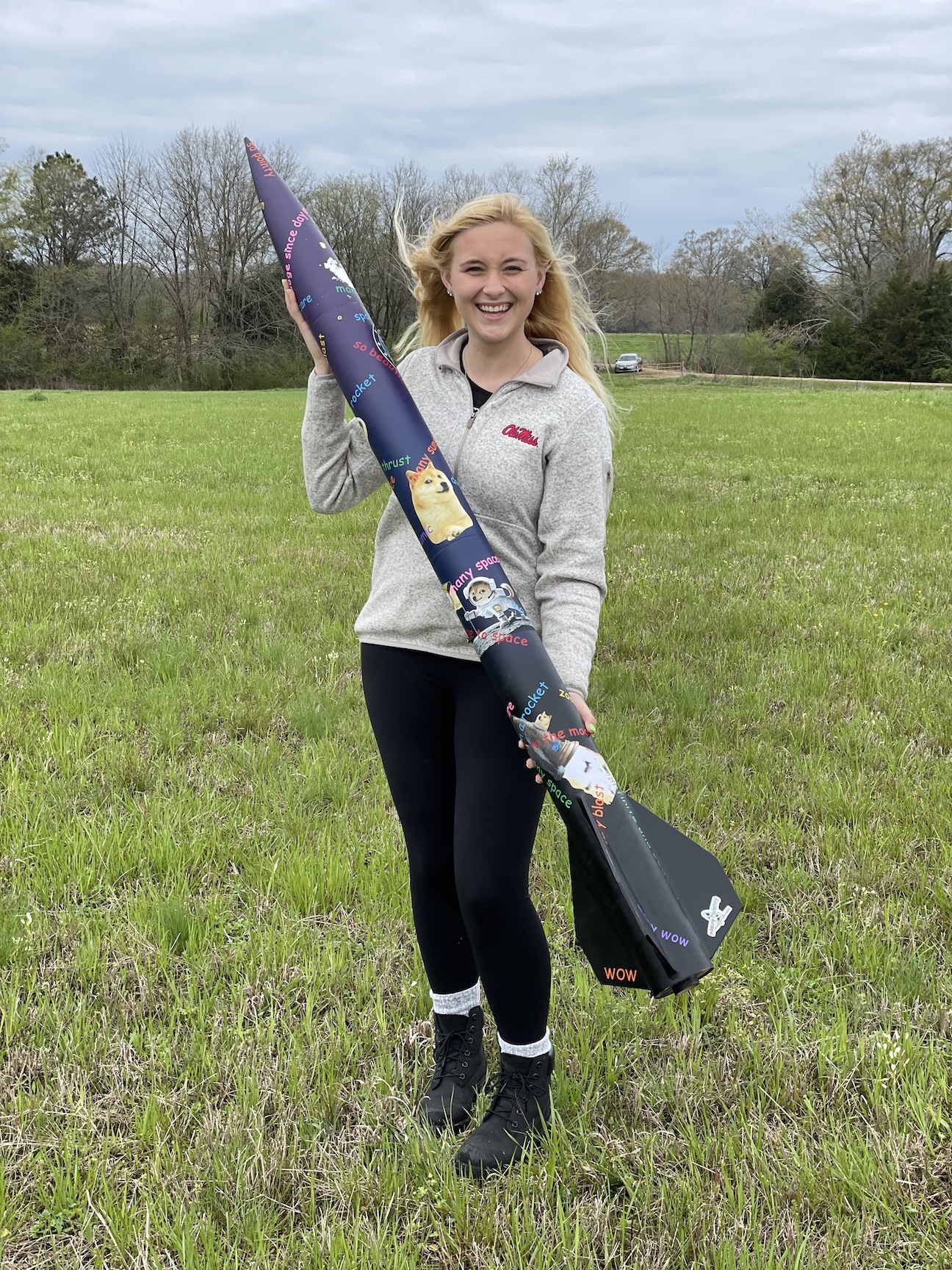 Stephanie and the rocket she built for her Level 1 High Power Rocket Certification.