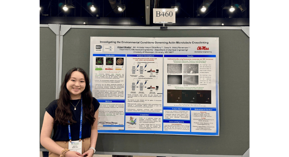 An image of Abigail Moeller smiling in front of her presentation at the Biophysical Society Annual Meeting in Los Angeles, CA. 
