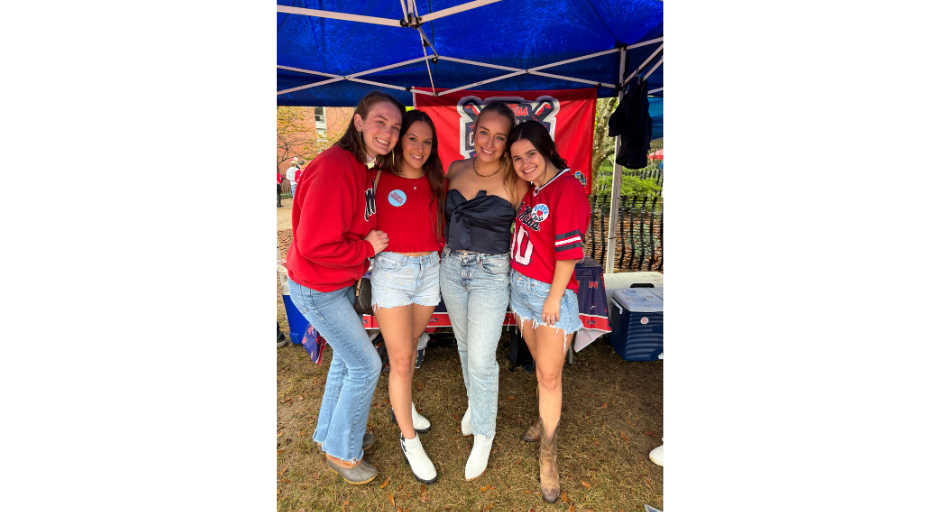 Emma Atkinson, Samantha Saraceno, Annie Caroline Holcomb and Emily Taylor smile for a gameday photo in the Grove.