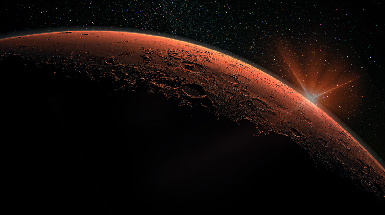 The sun rises over the surface of a reddish, heavily cratered planet with stars in the background.