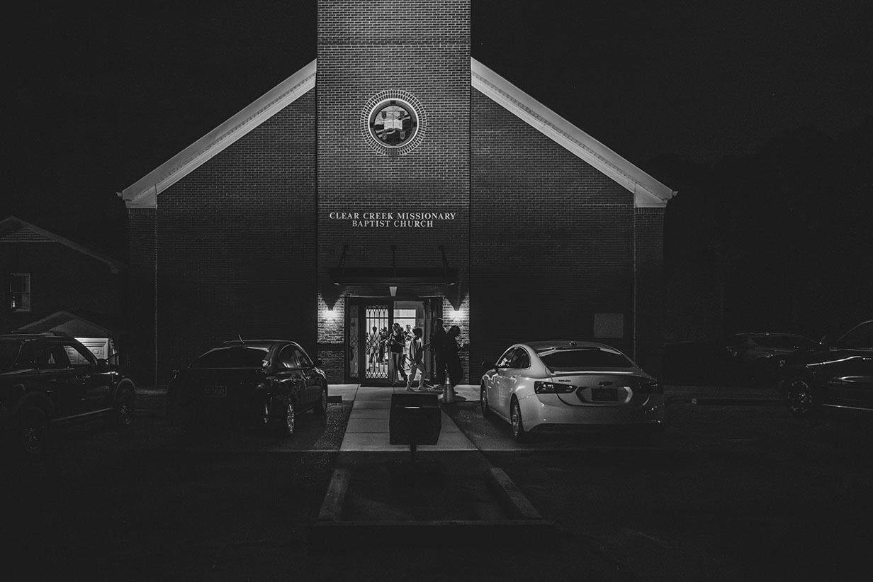 Gospel Choir disperse in outside Clear Creek Missionary Baptist Church as evening turn to night.