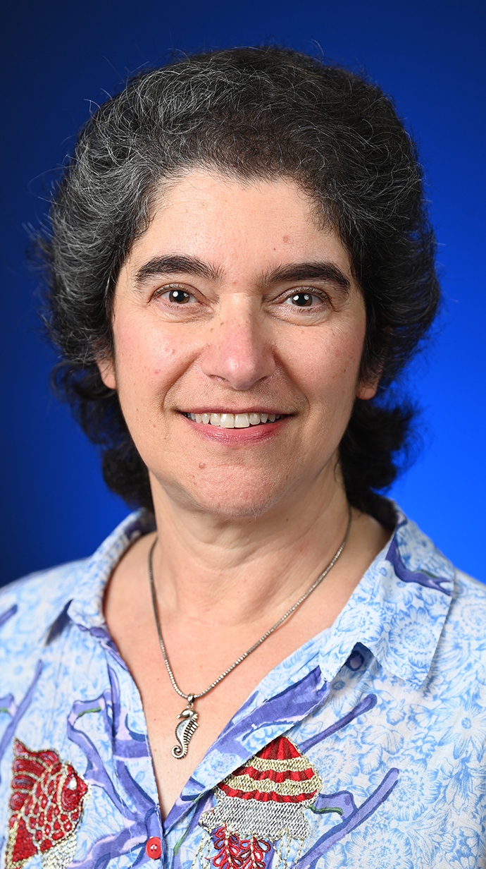 Head shot of a woman wearing a flowered blouse.