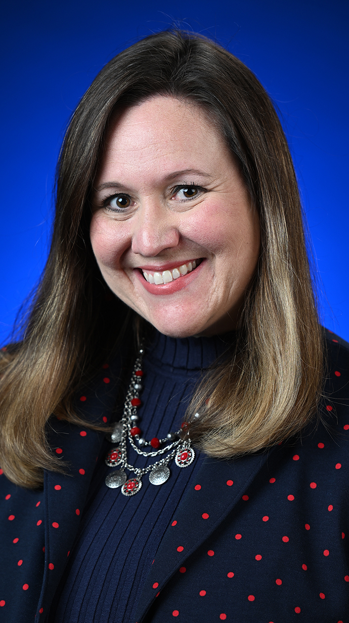 Headshot of a woman wearing a black blouse.