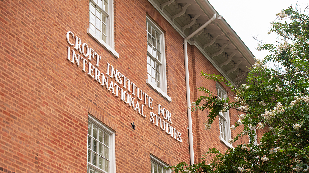 Exterior of a two-story red brick building with lettering reading 'Croft Institute for International Studies.'