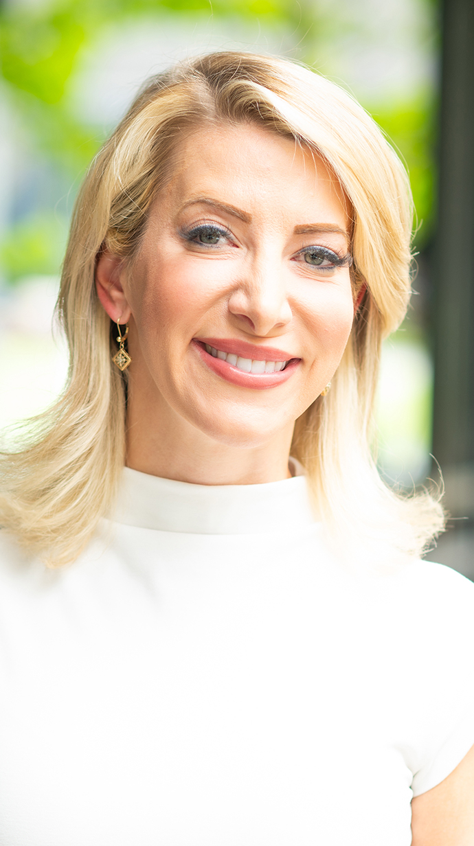 Portrait of a blonde woman standing outdoors.