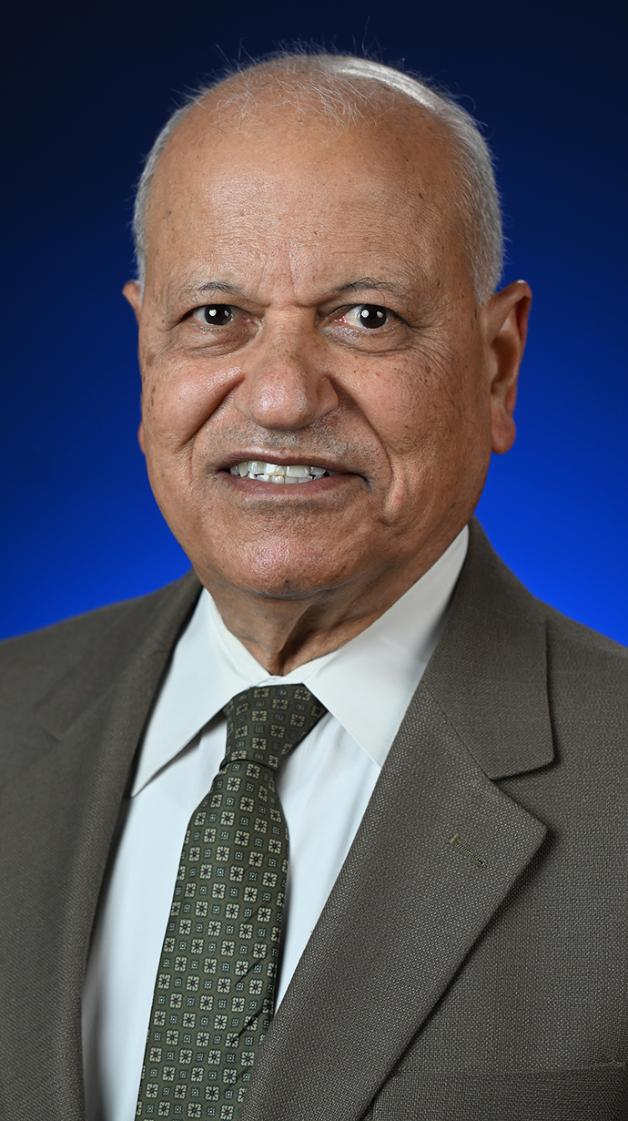 Portrait of a man wearing a brown suit.