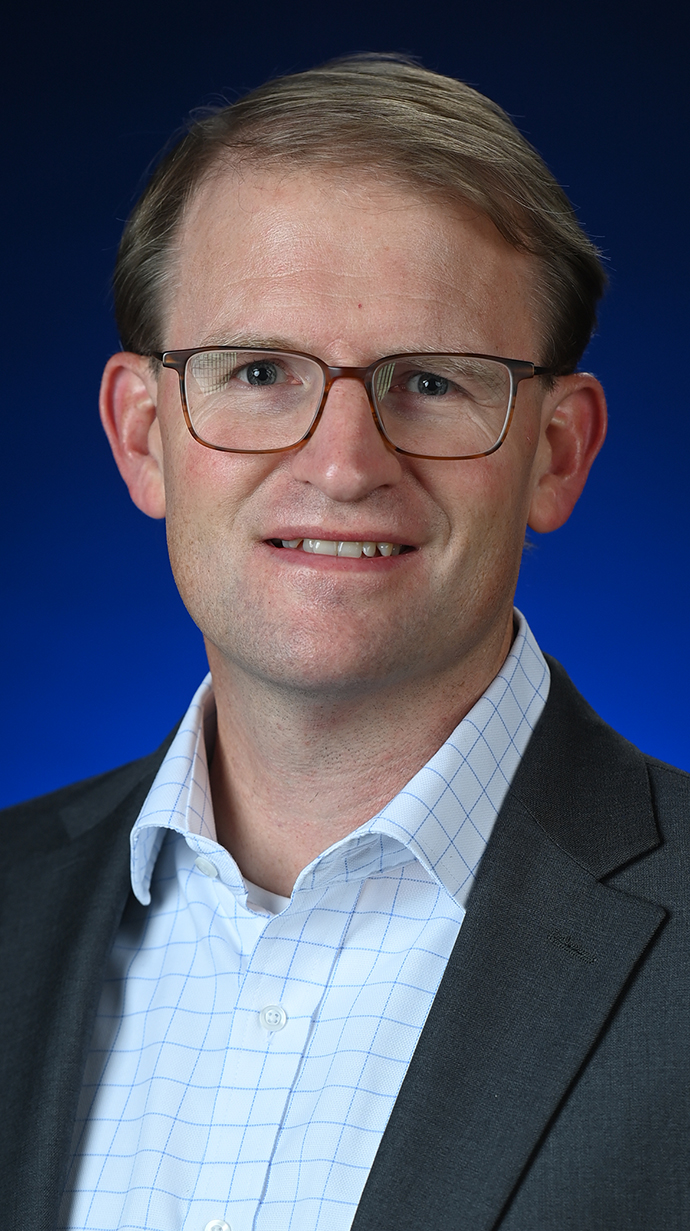 Headshot of a man wearing glasses.