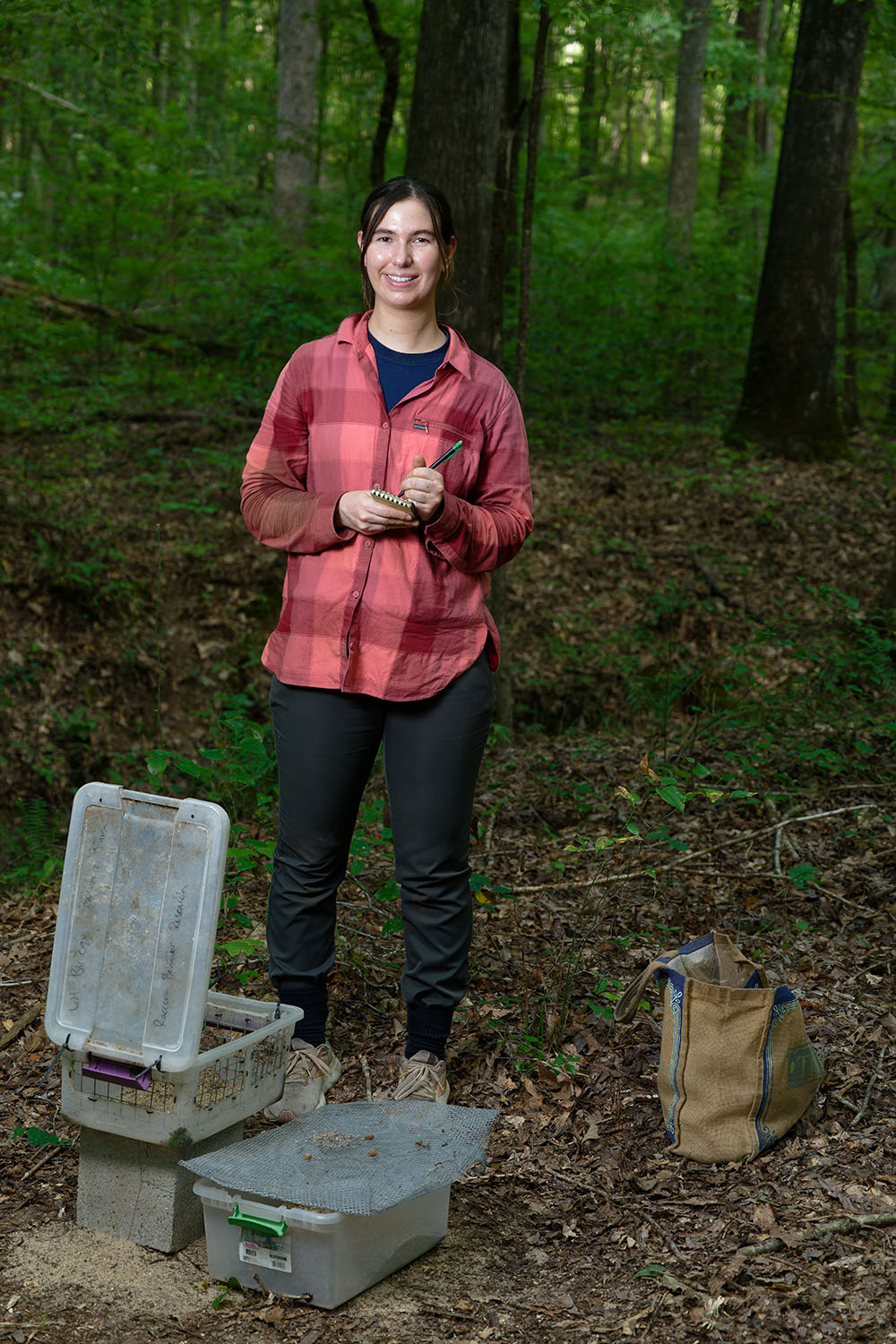 Jessica Stamn poses for a photo in a forested area.