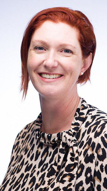 Headshot of a woman wearing a leopard-print blouse.