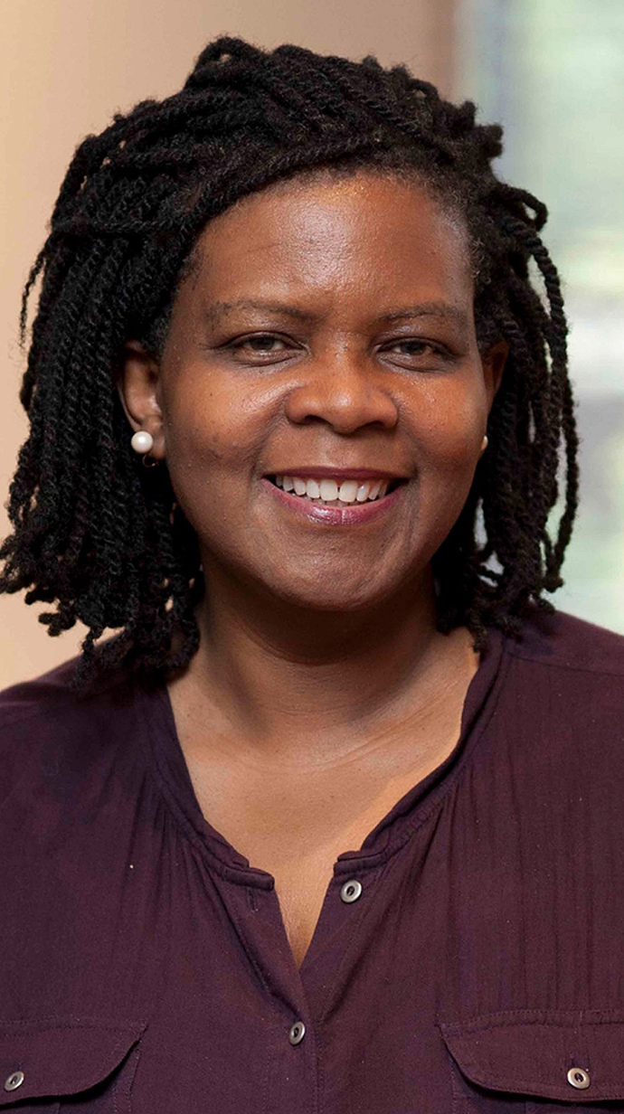Headshot of a woman wearing a purple blouse.