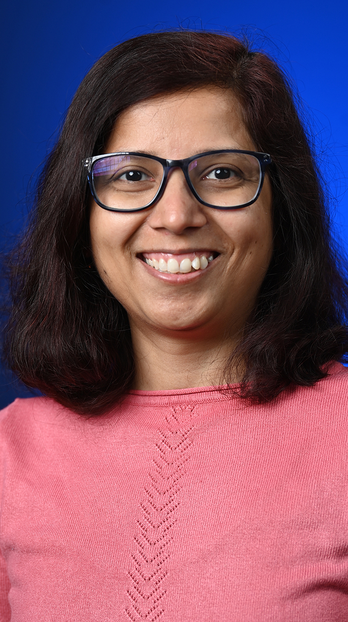 Headshot of a woman wearing a pink sweater.