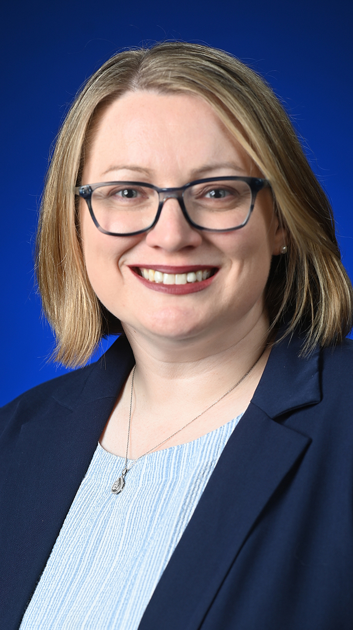 Headshot of a woman wearing a blue blazer.