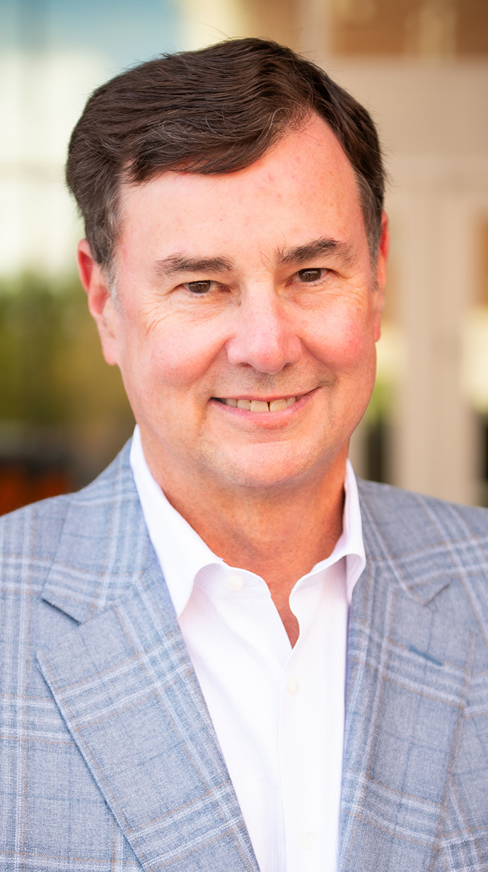 Headshot of a man wearing a light blue sportcoat.