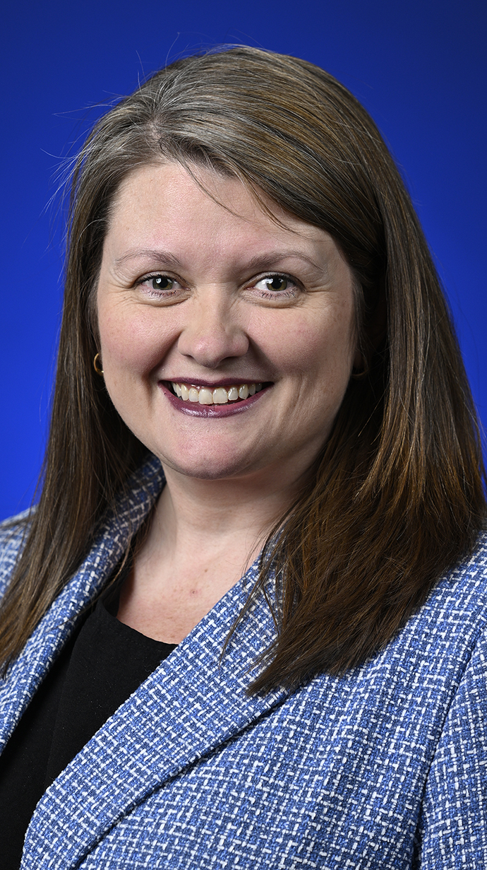 Headshot of a woman wearing a light blue jacket