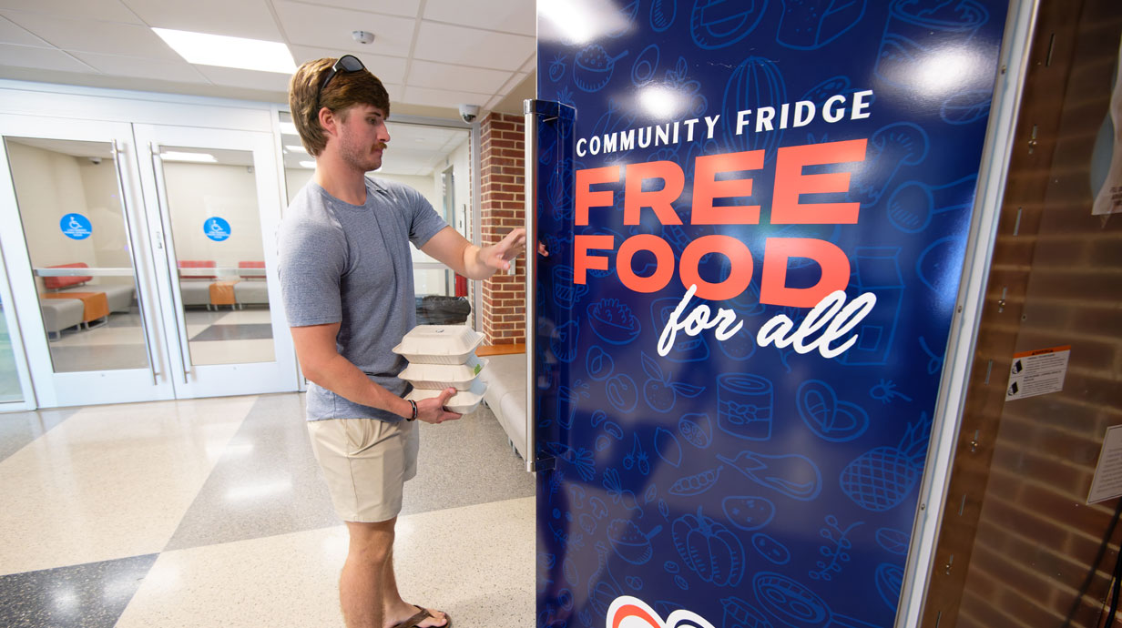 Jack Beaird, a senior business and entrepreneurship major from Dallas, stocks the new Grove Grocery refrigerator with lunch meals he packed from the Kappa Alpha Order fraternity house. Located in the Transit Center at the Gertrude C. Ford Student Union, Viking Range donated the large appliance, helping the university better support students. Photo by Hunt Mercier/Ole Miss Digital Imaging