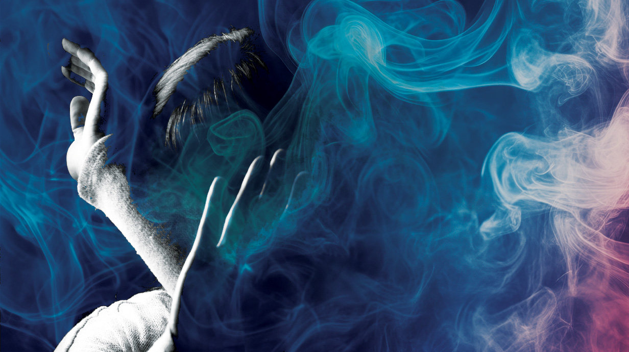 Photo illustration of smoke swirling around a person in a defensive posture, with arms raised to shield their head.