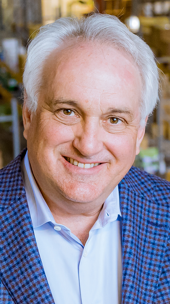 Headshot of a man wearing a blue sportcoat.