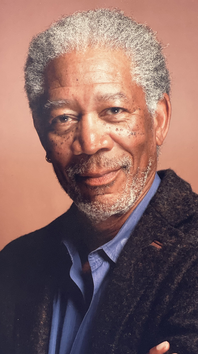 Headshot of a man wearing a dark wool jacket over a blue shirt.