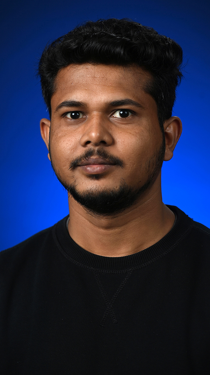 Headshot of a man wearing a black sweatshirt.